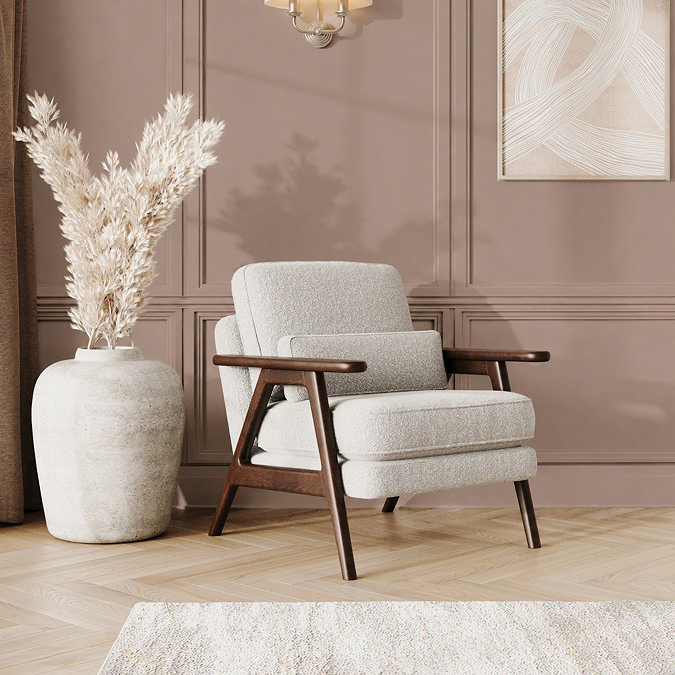 lifestyle image of soft boucle cocoon coloured accent chair with warm oak frame in mid-century style