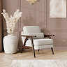 lifestyle image of soft boucle cocoon coloured accent chair with warm oak frame in mid-century style