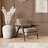 lifestyle image of mid-century accent chair in latte chenille-velvet fabric with warm wood frame