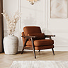 lifestyle image of mid-century accent chair in mandarin chenille-velvet fabric with warm wood frame