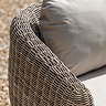 close up on rattan sides of outdoor sofa with plush cream cushions