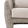 image cut out on white background of rattan sofa with plush cream cushions, focus close up on texture of materials