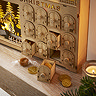 close up on drawers of wooden advent calendar, filled with mini chocolate coins and toffees placed on the mantlepiece.