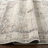 close up image of light brown rug slightly ruched to show its thinness