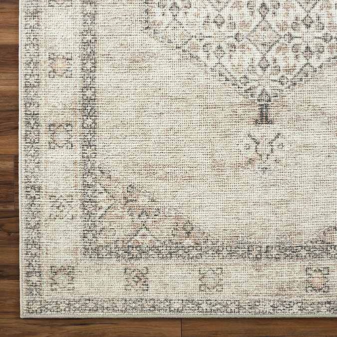 close up swatch image of vintage rug with brown florals and delicate border