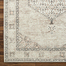 close up swatch image of vintage rug with brown florals and delicate border