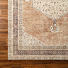 close up swatch image of tan and brown rug with vintage pattern