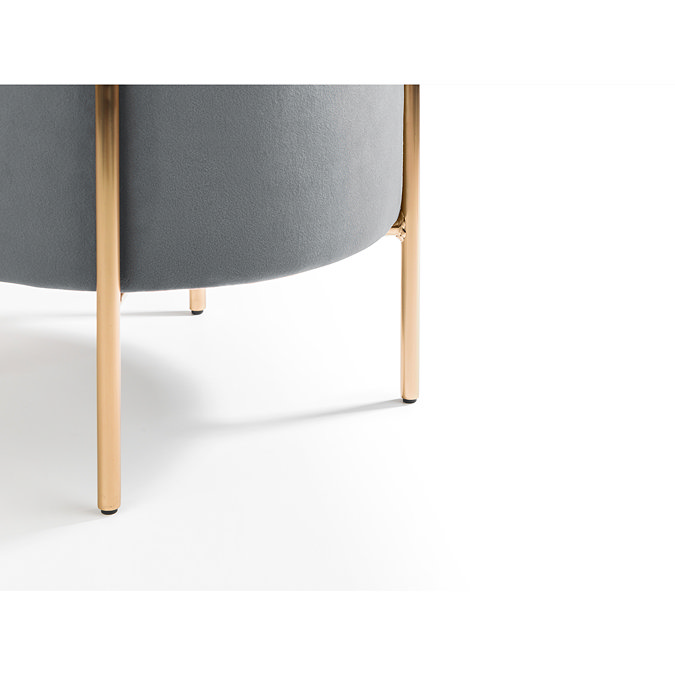 close up on gold legs of velvet grey stool, image cut out on white background