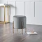 image of velvet grey with gold legs, stool on dark wooden floor