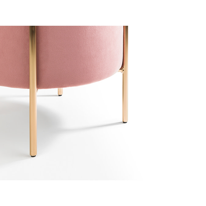 close up on gold accent legs of pink velvet pouffe