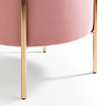 close up on gold accent legs of pink velvet pouffe