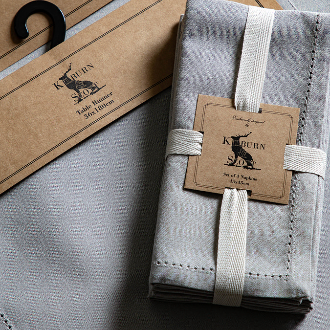 image of dove grey pack of 4 linen style napkins wrapped with cream ribbon and brown cardboard brand label