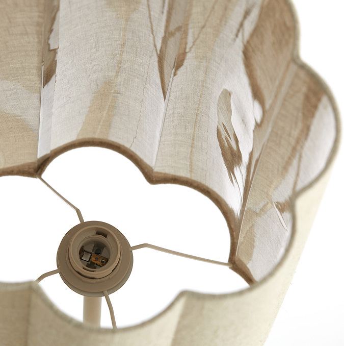 image taken from above of linen coloured lamp shade with petal-shaped edging, showing inside where bulb will sit