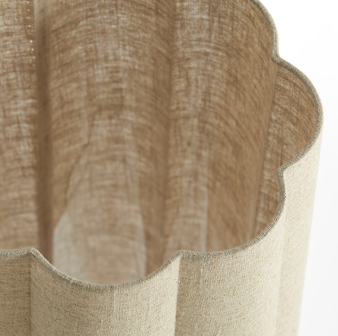 close up image taken from above of linen coloured lamp shade with petal-shaped edging