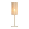 image cut out on white background of linen cylindrical table lamp with bulb emitting a warm glow