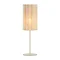 image cut out on white background of linen cylindrical table lamp with bulb emitting a warm glow