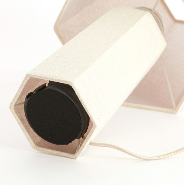 image of cream lamp on its side to show exposed black base where cable connects
