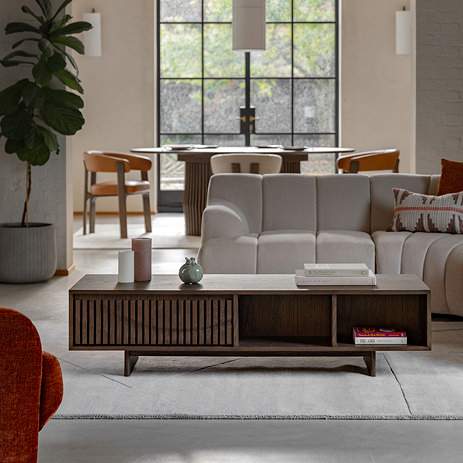 image of rectangular walnut coffee table with wave-panelled door and shelf space