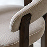 close up image of natural fabric of rounded dining chair arms