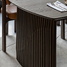 close up image on wavy slatted legs of walnut dining table