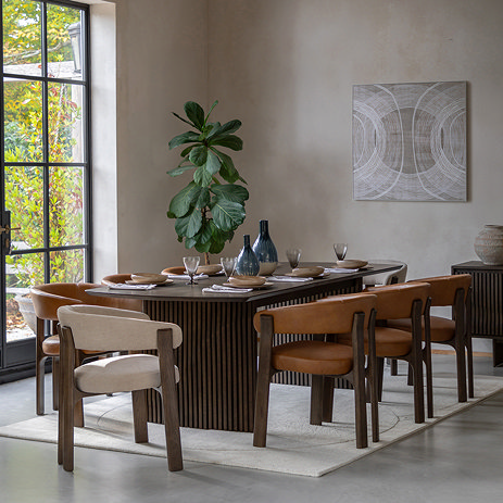 image of extendable walnut dining table with eight chairs around it to show its generous size