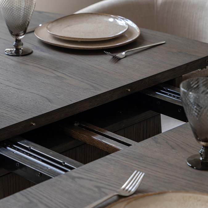 close up image of extendable function in the middle of walnut dining table
