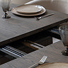 close up image of extendable function in the middle of walnut dining table