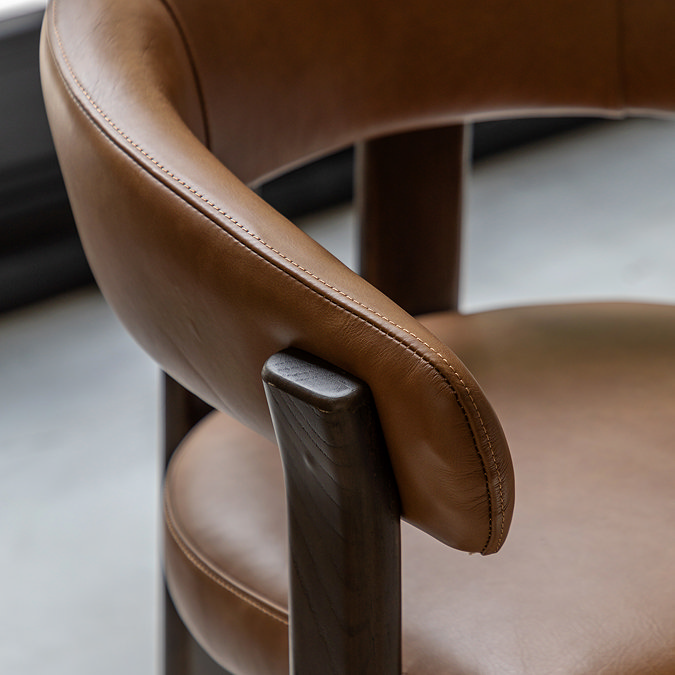 close up image of rounded back of brown dining chair 