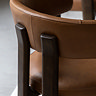 close up image of ash wood back of brown leather dining chair