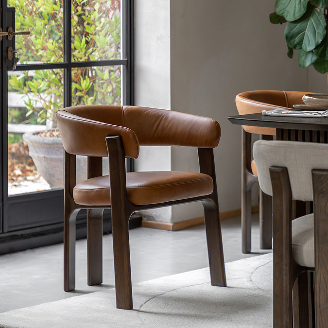 image of brown leather dining chair with rounded back and ash wood legs