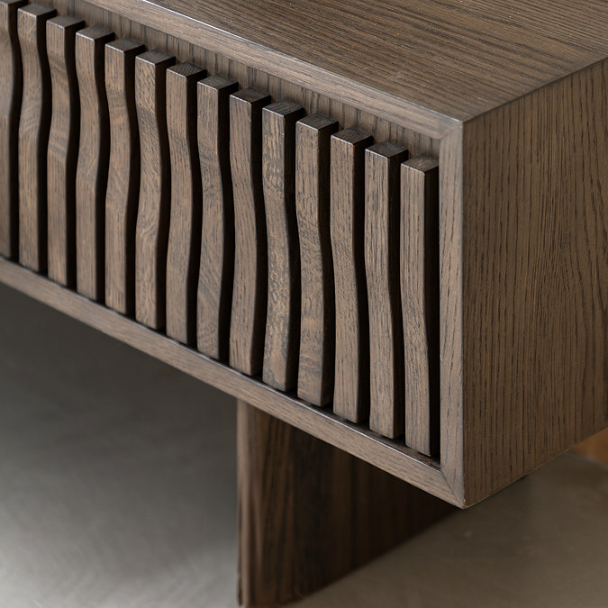 close up image of wave panelled door of walnut tv unit