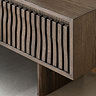 close up image of wave panelled door of walnut tv unit