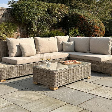 close up image of plush cushions and rattan backing of outdoor corner set