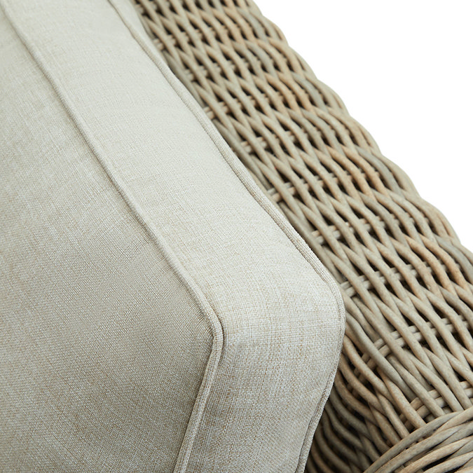 close up image of plush beige cushion of outdoor rattan sofa