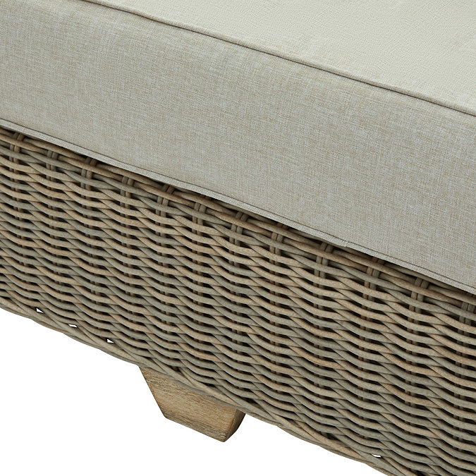 close up on bottom of rattan sofa showing the short acacia wood legs