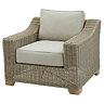 image cut out on white background of beige rattan armchair with plush cushion and light wood feet