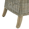 close up image cut out on white background of beige rattan dining chair with light wood feet