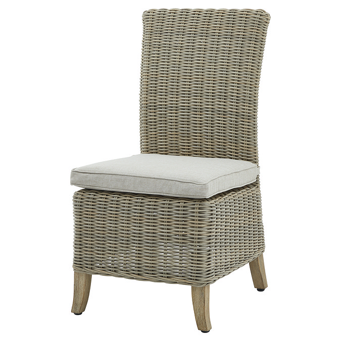 image cut out on white background of rattan dining chair with beige seat pad