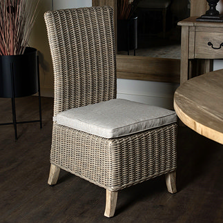 image of rattan outdoor dining chair with deep seat and beige seat pad
