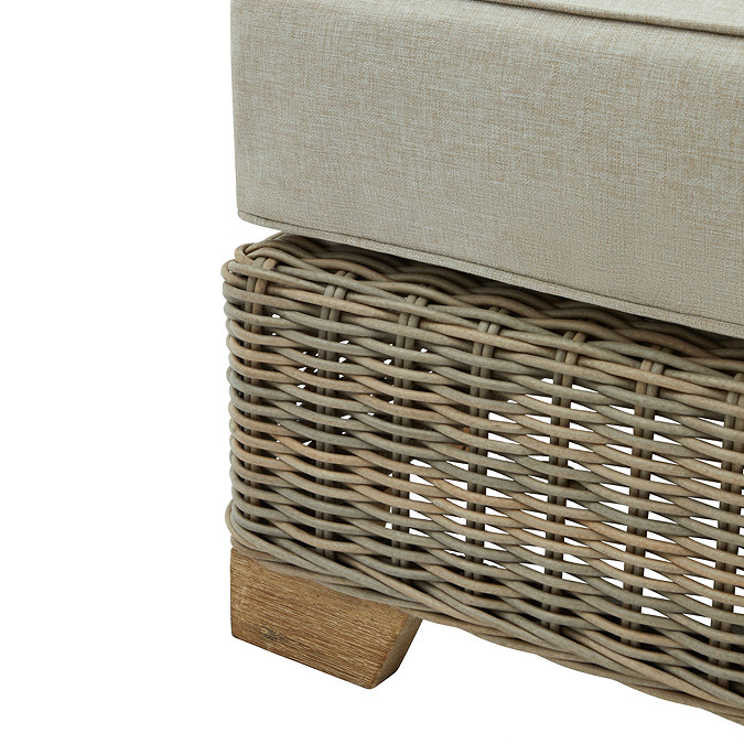 close up image of rattan base and acacia wood feet of garden footstool
