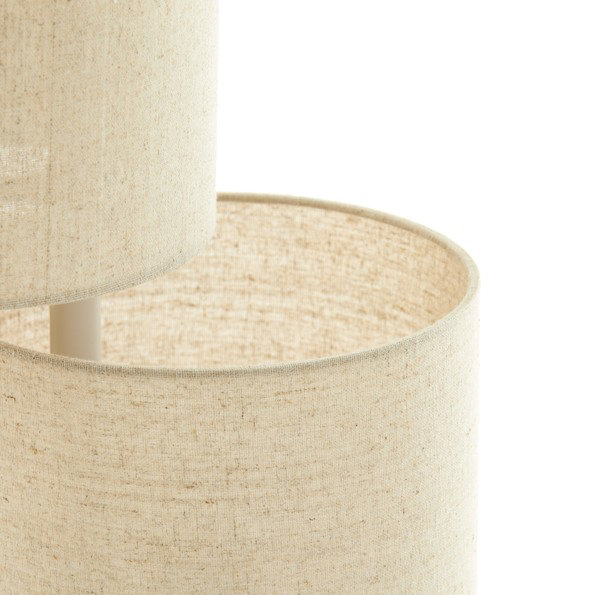 close up on one cylindrical natural coloured shade of floor lamp