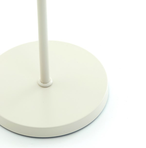 close up on cream circular base of loki floor lamp