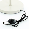close up image of circular cream base of floor lamp with slim black cable attaching press switch