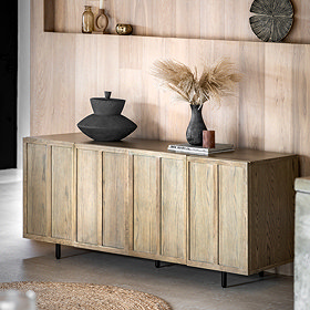 image of smoked oak panelled sideboard with 7 vertical panels, topped with a black vase and a faux plant