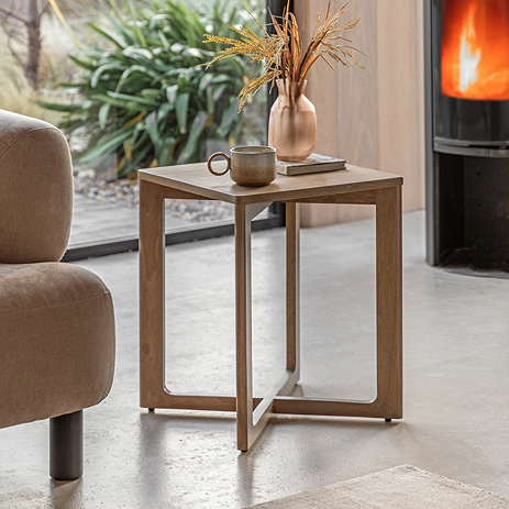 image of panelled sideboard next to a cream armchair