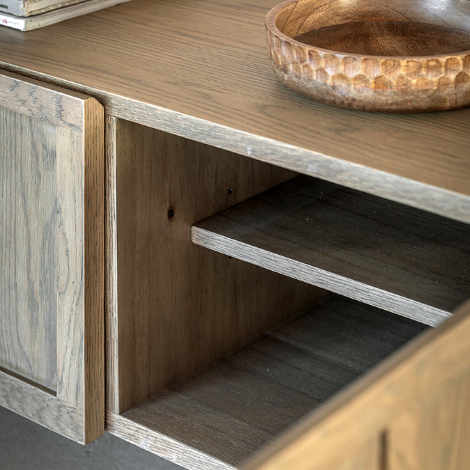 close up image on media unit with door open to reveal shelf space inside