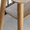 close up on light oak-effect of console table with open lower shelf and smooth round legs