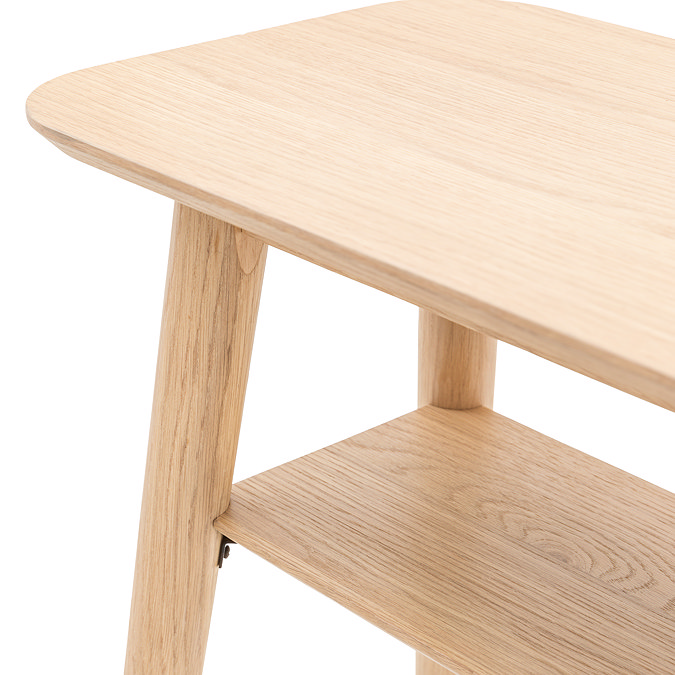 image cut out on white background of light oak console table with curved edges and lower shelf