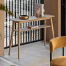image of oak console table with shelving space, topped with stylish home accessories and books on the lower shelf