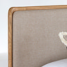 close up on natural coloured fabric material of headboard with smooth oak edges